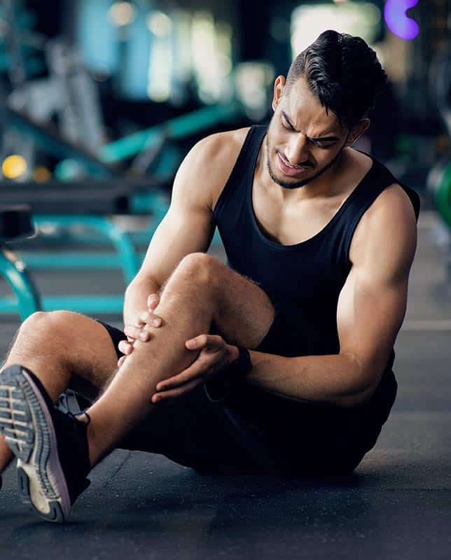 Athlete Holding Leg in Injury