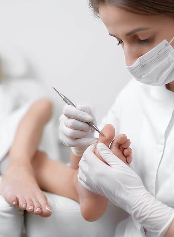 Doctor Performing Podiatric Treatment on a Patient's Foot