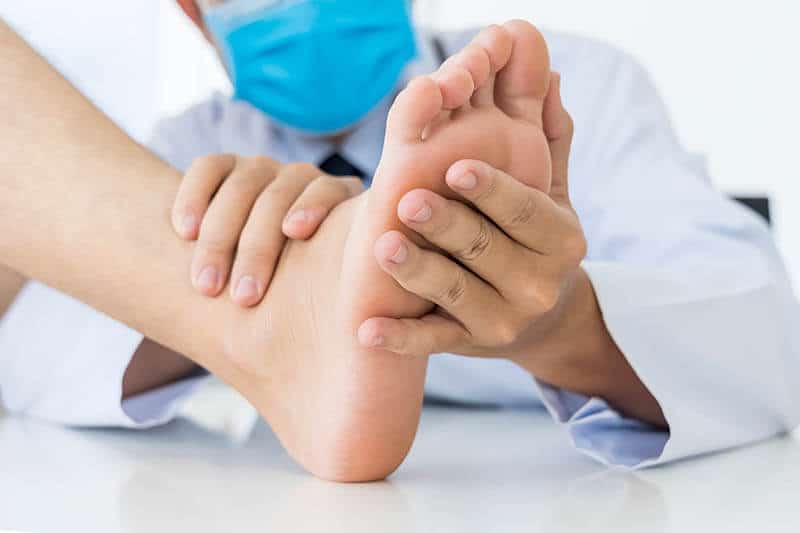 Doctor checking out flat foot