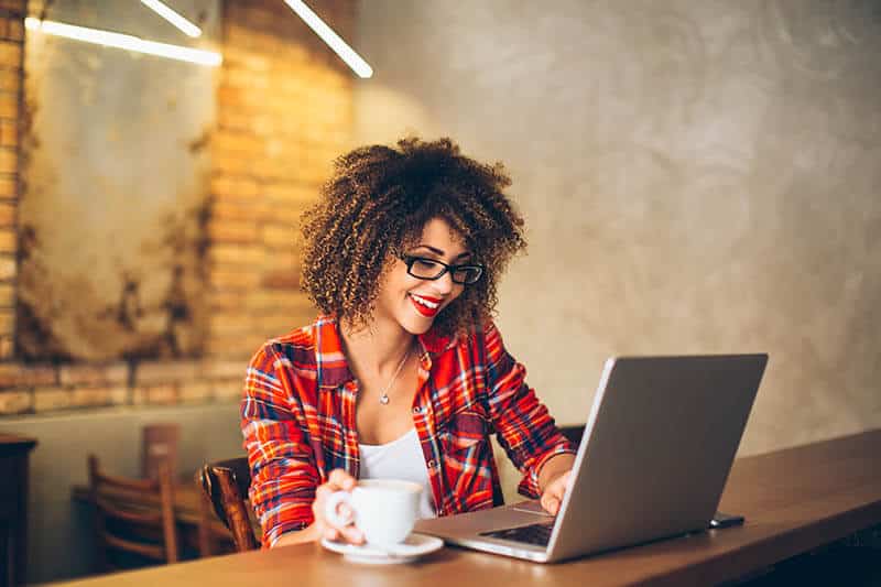 Woman on her laptop computer with coffee